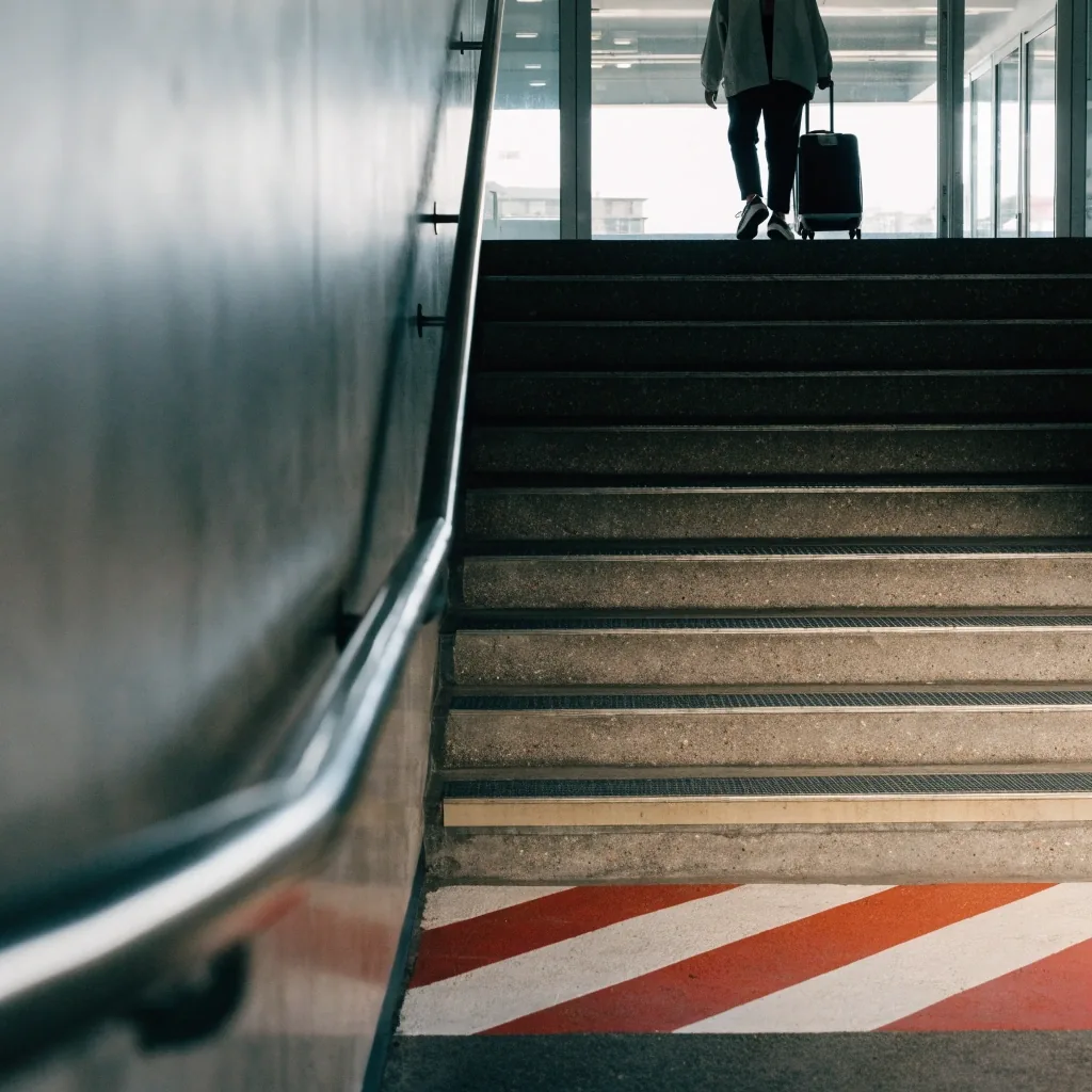 Traveller walking from the terminal car park toward the terminal doors